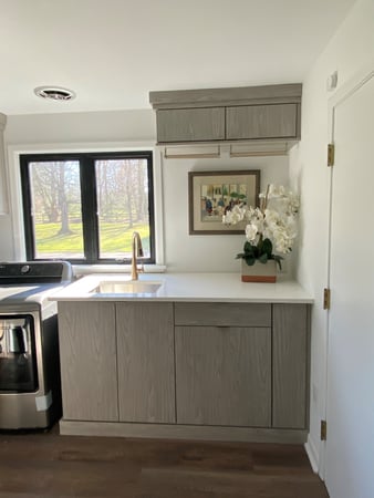 Custom laundry room storage and sink by California Closets Cleveland, Ohio.