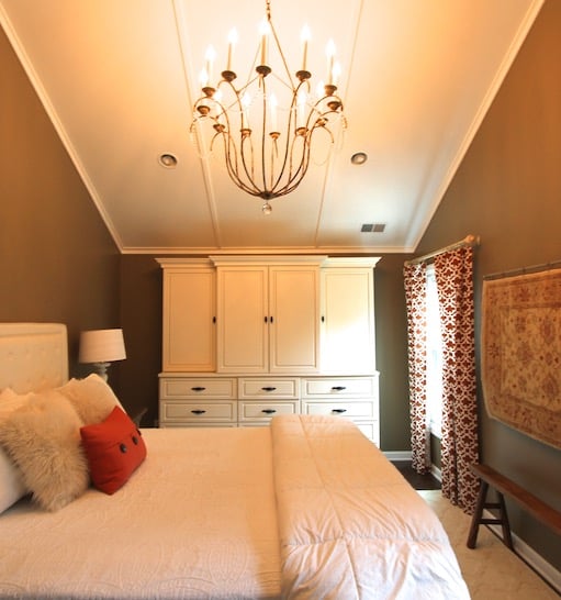 Traditional master wardrobe with rustic chandelier.