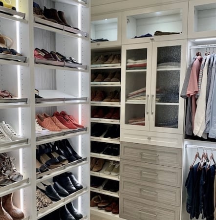 Walk-in closet with dresser, shelving, hanging storage, and shoe racks by California Closets Atlanta.