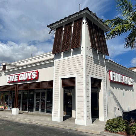 Exterior photograph of the Five Guys restaurant at 18421 NW 67th Avenue in Hialeah, Florida.