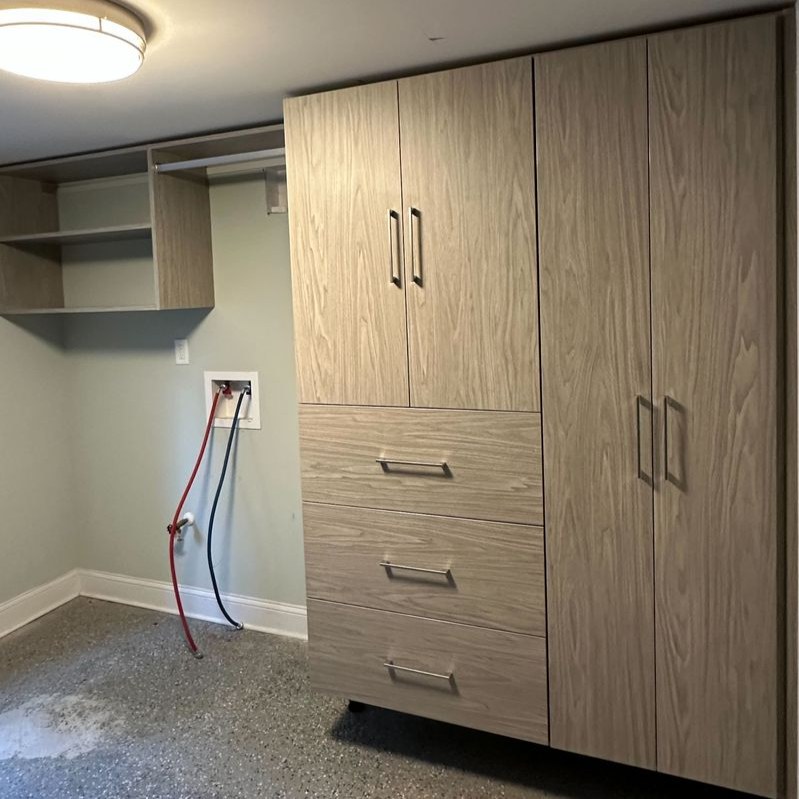 Greensboro - Custom closets - custom wood-finish laundry cabinets with drawers, tall doors, and wall-mounted storage