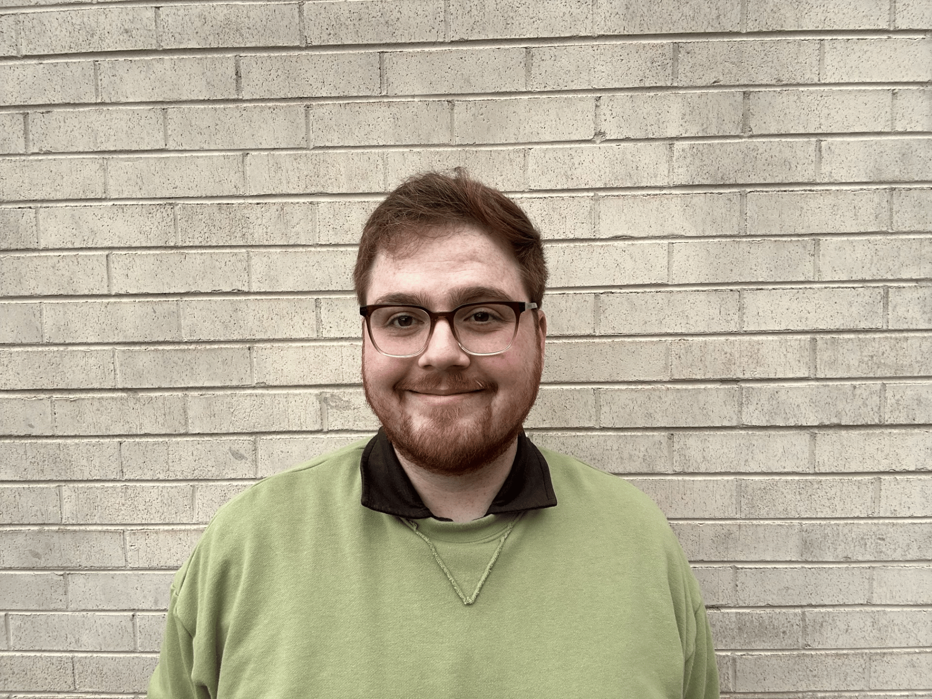 man with red hair Connor Bowser brick background