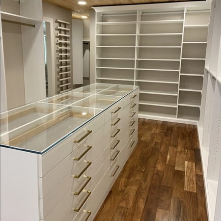 White custom closet organization with shoe organization and gold hardware California Closets New Orleans & Gulf Coast