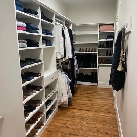 Walk-in closet with shoe rack, shelving and wall hooks.