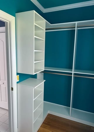 Wilmington - Custom closets - Custom white closet with double hanging rods and open shelving against teal walls.