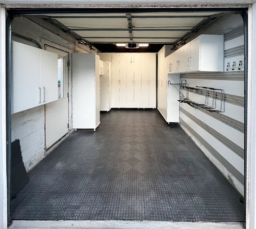 Custom storage cabinets and utility wall rack in white finish designed by California Closets Southern New Jersey