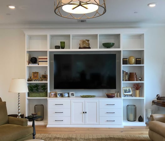 White media center with bookshelves and center TV