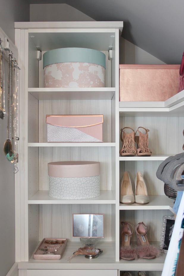Walk in closet designed in a light wood grain finish. Open shelving and jewelry hooks provide a perfect place for displaying your items.