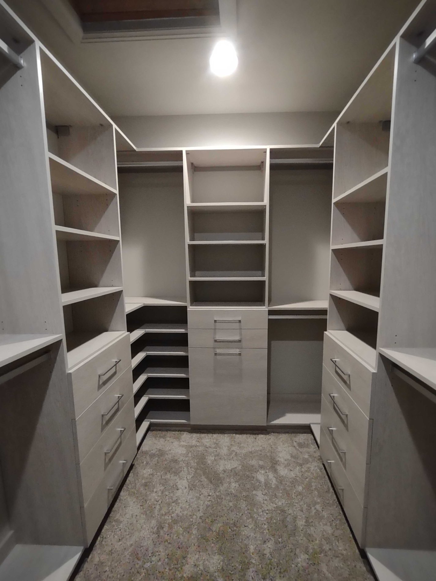 Walk in closets with a light, drawers, and shelves