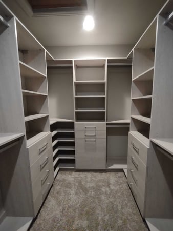 Walk in closets with a light, drawers, and shelves