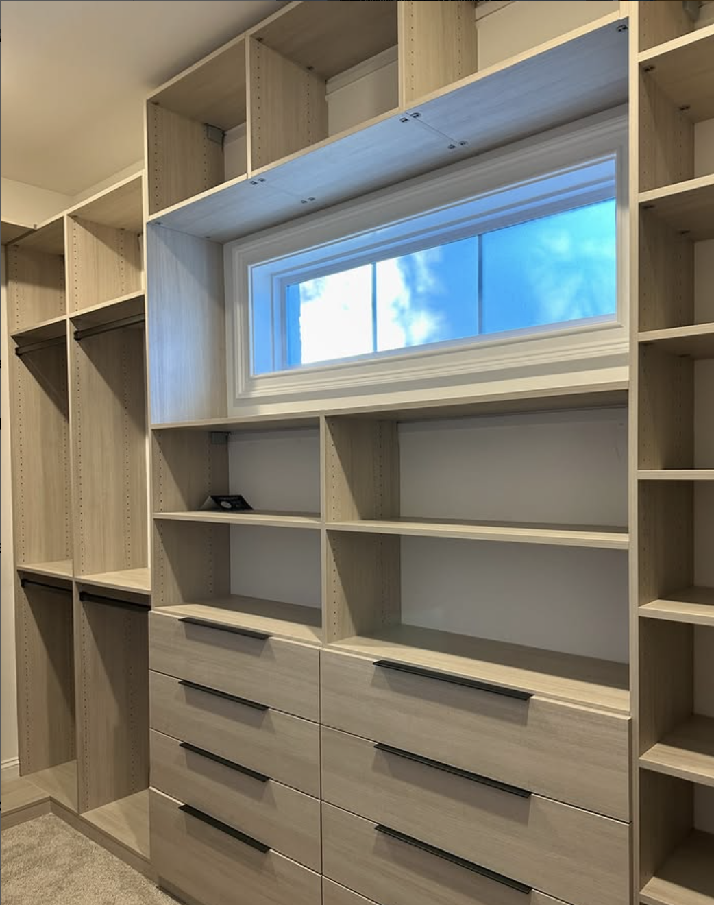 Custom walk-in closet with view of outside.