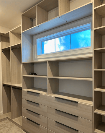 Custom walk-in closet with view of outside.