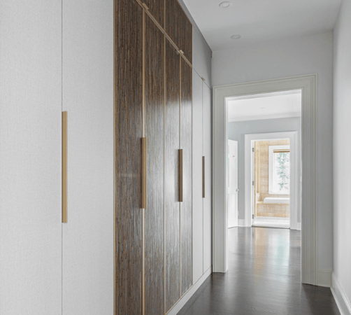 California Closets Westchester NY Two Toned White and Bronze Resin Doors Closed Cabinetry with Gold Handles