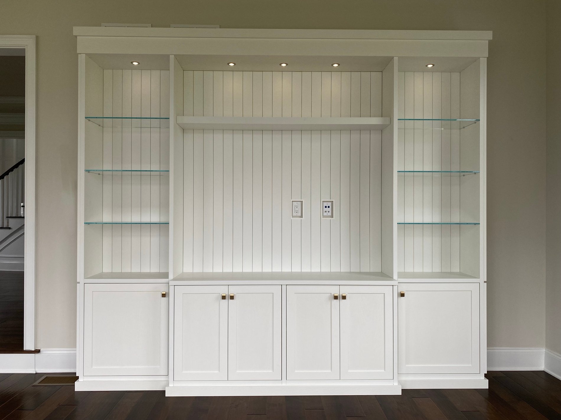 White media center with lower cabinets and shiplap backing