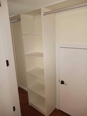 Mixed reach-in closet with shelving, aluminum rods and classic white finish.