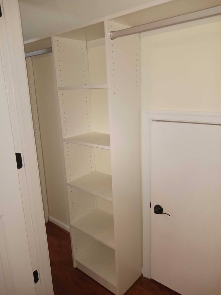 Mixed reach-in closet with shelving, aluminum rods and classic white finish.