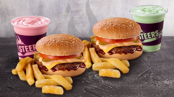 Sharing meal on a granite surface with 2x Original Steers® cheese burgers, medium chips and 2x 250ml shakes.