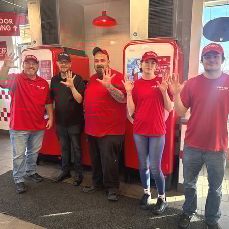 Crew members pose for a photograph ahead of the reopening of the Five Guys in Broomfield, Colorado.