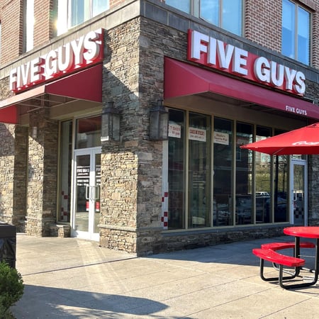 Exterior photograph of the Five Guys restaurant at 45 River Road in Edgewater, New Jersey.