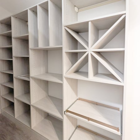 Pantry in a light finish with wine storage, pull out shelves, vertical shelving, and open adjustable shelves.