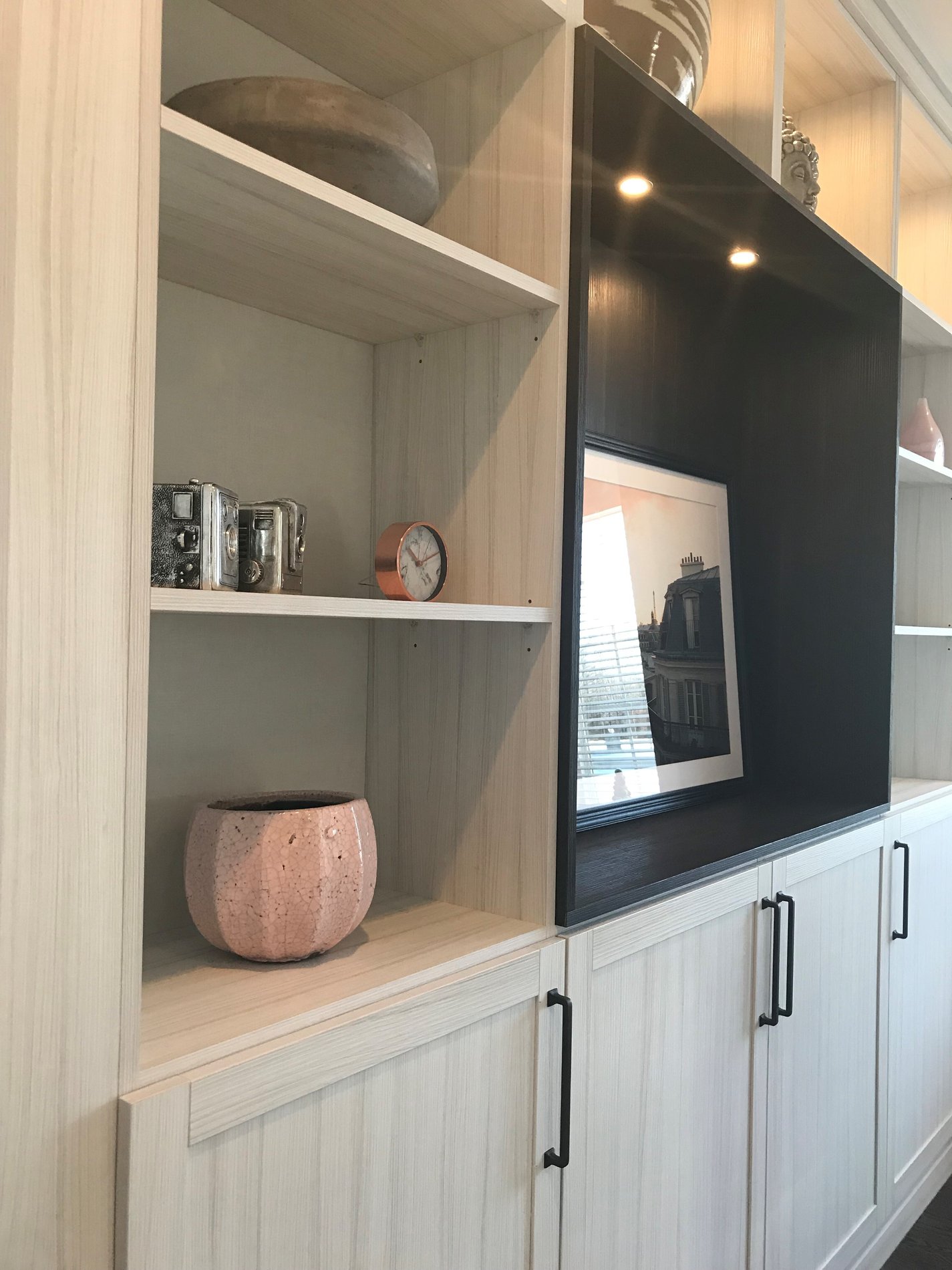 Bookshelves and cabinets in light and dark finishes