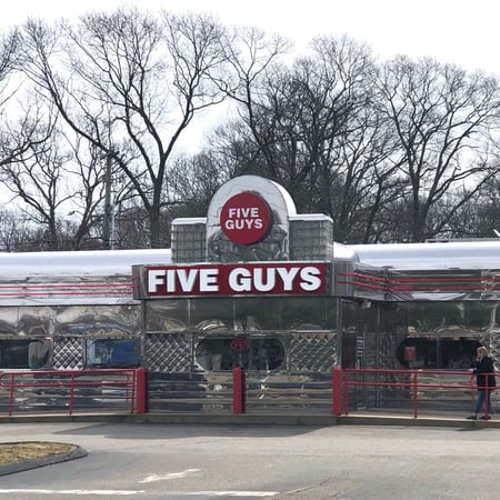Exterior photograph of the Five Guys restaurant at 143 Gold Star Highway in Groton, Connecticut.