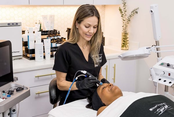 Patient receiving treatment from provider at SkinLab Winter Park.