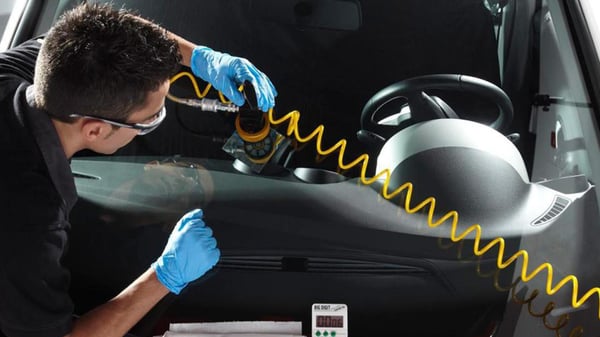 A Belron® mechanic working on a customer's vehicle.