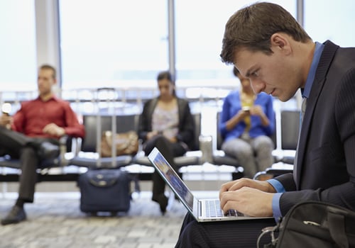 Homme travaillant sur ordinateur portable à l'aéroport