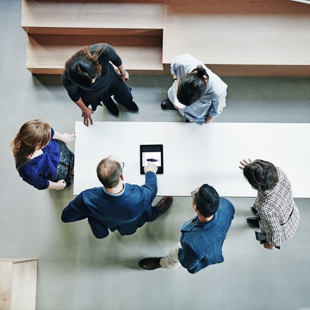 Overhead image of team meeting around a table