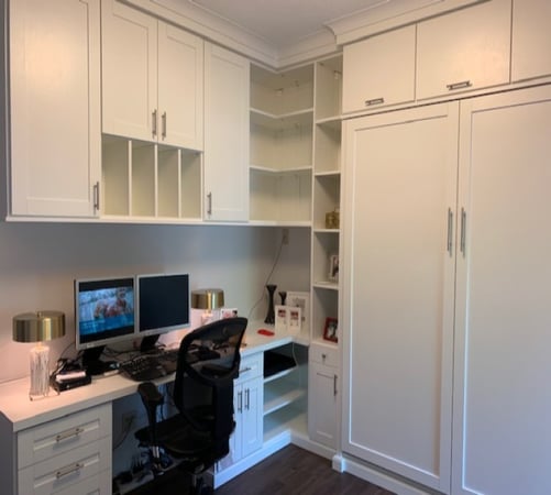 Office and wall bed, detailed in white shaker with bar handles, upper cabinets, corner shelving and finished with crown molding