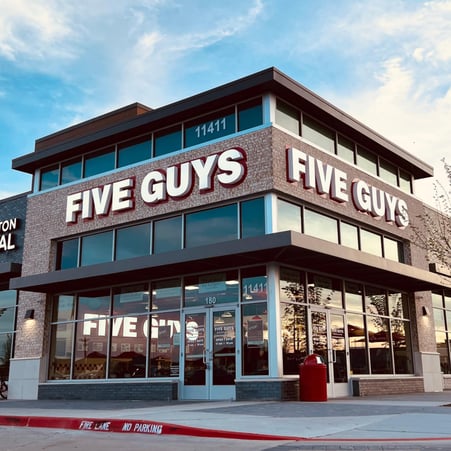 Exterior photograph of the Five Guys restaurant at 11411 Coit Road in Frisco, Texas.