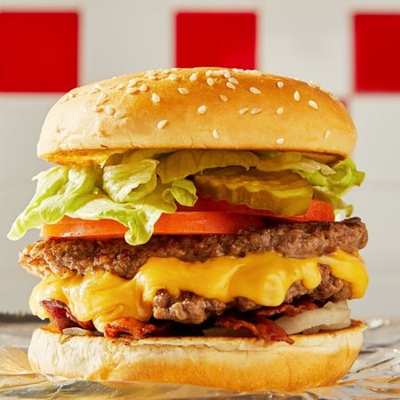 A close-up image of a Five Guys cheeseburger