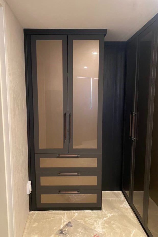 Luxe brown walk in closet with custom storage and wardrobe by California Closets Baton Rouge, Louisiana.