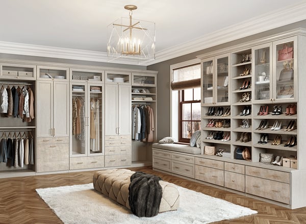 Walk-in closet with cabinets, shelves, drawers, and shoe storage in light wood by California Closets Gulfport & Hattiesburg Mississippi.