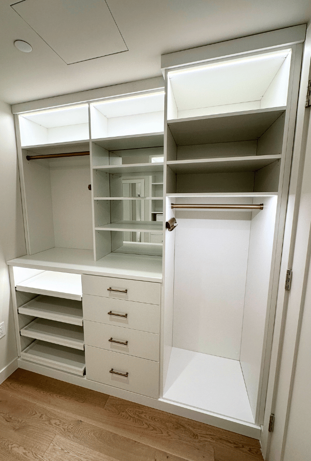 Img 3 - California Closets New York Designer Lea Nardi White Walk-in Closet with LED lighting, hanging, shelving, mirrored backing, drawers and open pull-out shelving