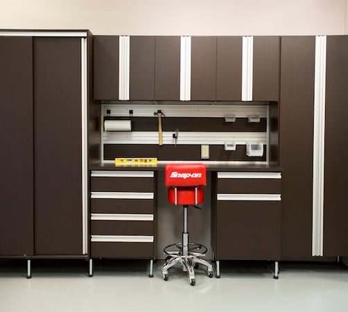 custom garage workspace storage with slat wall and cabinets