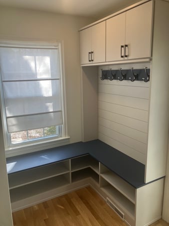 Custom mudroom with a bench and above head storage.