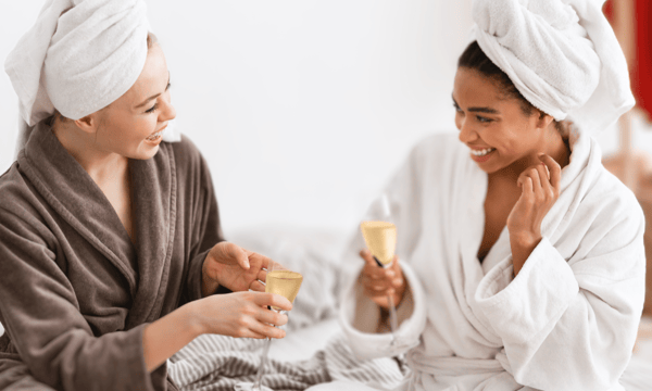 two women at spa holding champagne glasses