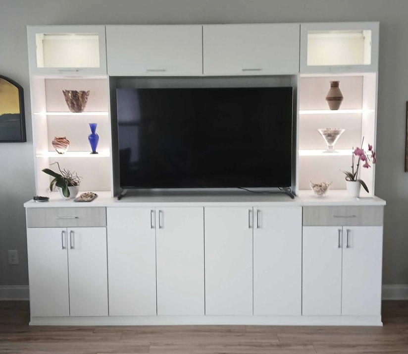 White cabinets and lit shelving for a living room or bedroom wall.