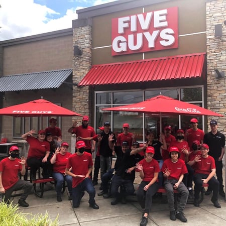 Five Guys crew members pose in front of store at 2902 164th Street SW in Lynnwood, Washington.