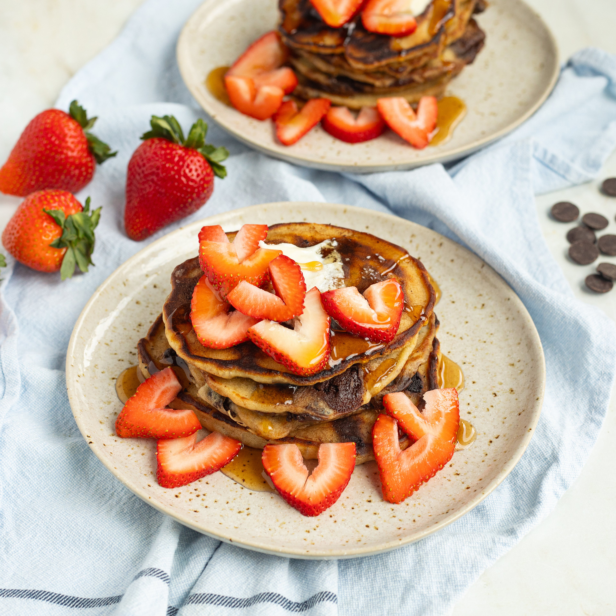 sweetheart chocolate chip pancakes with strawberries & maple syrup