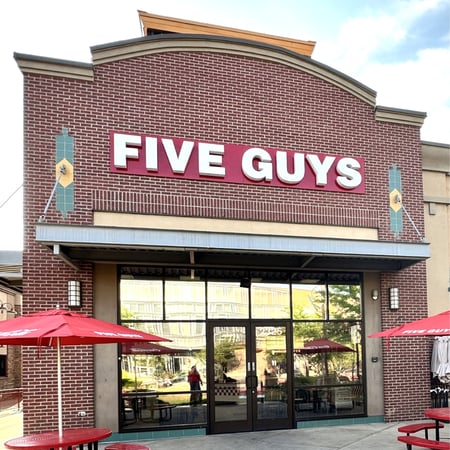 Exterior photograph of the entrance to the Five Guys restaurant in Ogden, Utah.