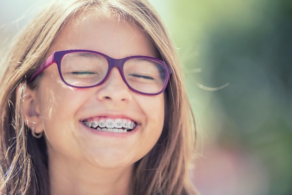 Smiling little girl with braces
