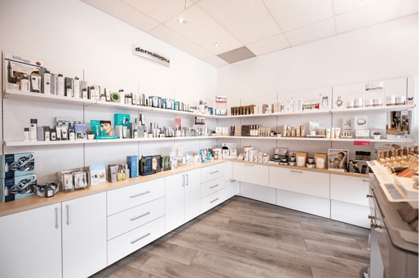 A large array of drawers and shelves used to display and storage skincare products in a retail location.