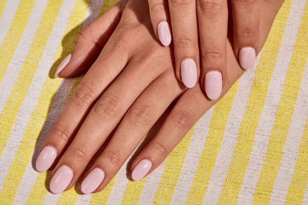 Beautifully manicured hands with fresh polish by Woodhouse Spa.