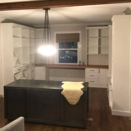 Wrap-around, floor-to-ceiling shelving in an office area.