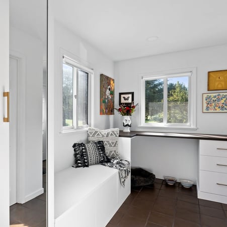 a mudroom featuring space for your pet, glass doors, and drawers with a bench