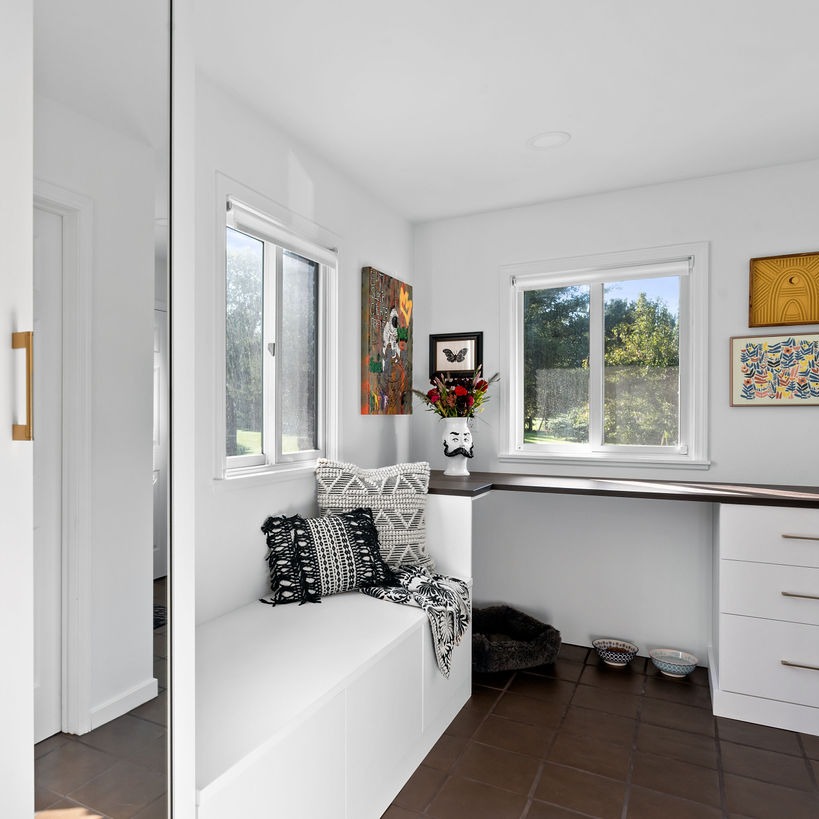 a mudroom featuring space for your pet, glass doors, and drawers with a bench