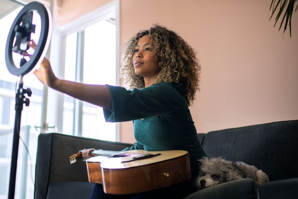 Women recording guitar streaming session